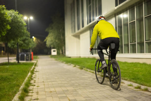 istock Man riding a bicycle in city at night 1813165181