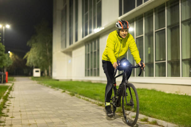 Man riding a bicycle in city at night