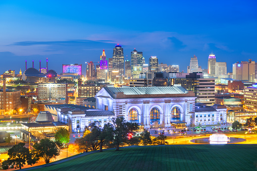 Kansas City, Missouri, USA downtown skyline with Union Station at blue hour.