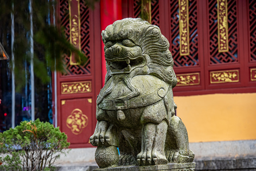 Stone lion sculpture in front of the temple