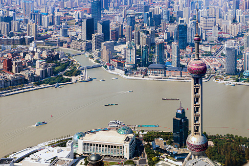 Aerial view of the iconic Shanghai Oriental Pearl Tower, Huangpu river and the urban buildings of Huangpu District in the background