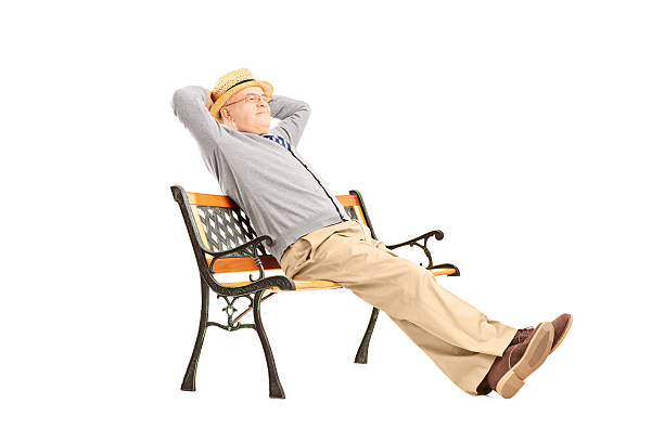 Mature man sitting on a wooden bench isolated on white background