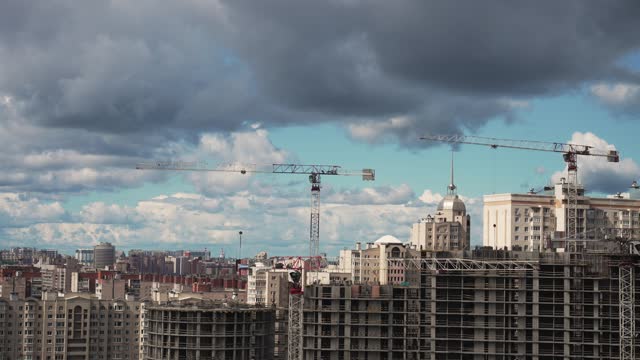 Construction building time-lapse. City industrial landscape. Beautiful clouds float across the blue sky.