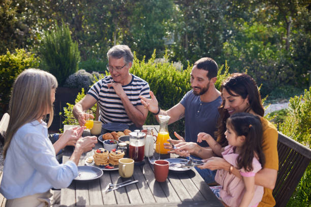 istock Smiling multi-generation family having lunch outside on their patio 1813197126