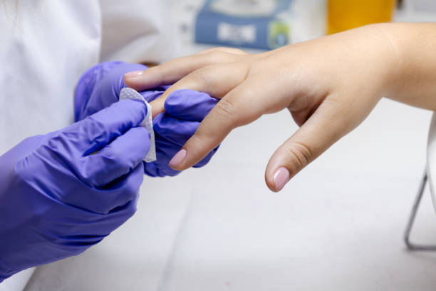 istock A manicurist treats a woman's cuticles with moisturizing wipe 1813203246