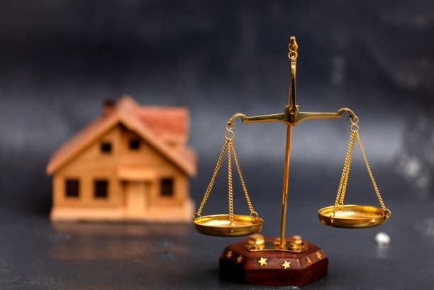 istock Scales of justice and a model house 1813207688