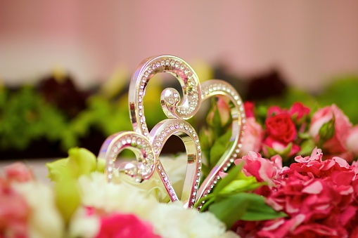Holiday decoration decor. A decorative element in the form of two hearts. The wedding ceremony.