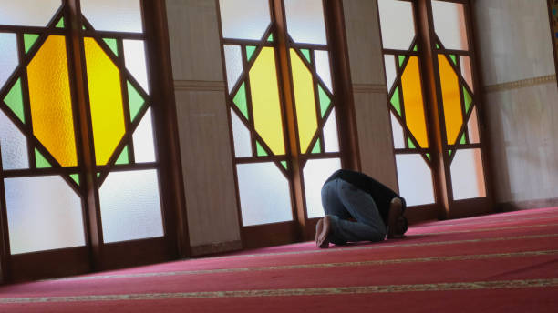 istock Indonesian Muslim man praying inside mosque alone 1813213191