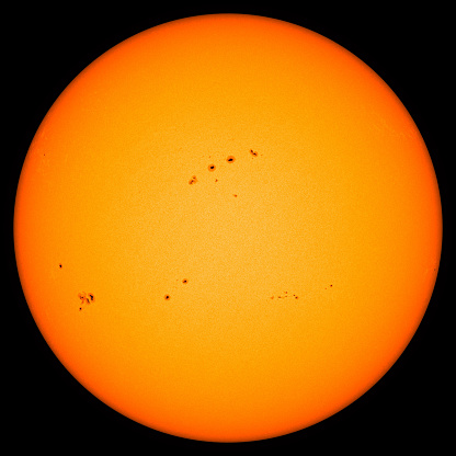 Detailed image of the sun where large groups of sunpots can be seen.