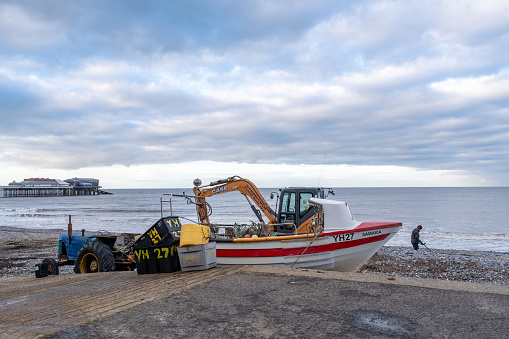 Cromer, Norfolk, UK - November 6 2023. Crab fishing boat moored on Cromer beach on the North Norfolk coast