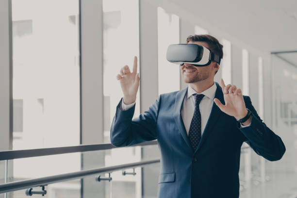 istock Professional in suit experiencing virtual reality in a bright, airy office environment 1813245694