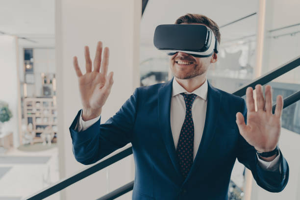 istock Businessman in VR headset navigating virtual reality, smiling in office setting 1813245697