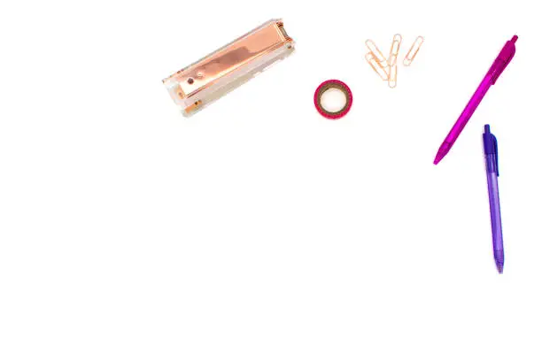 Photo of Flat lay office concept with white background and pink, purple, and rose gold office supplies