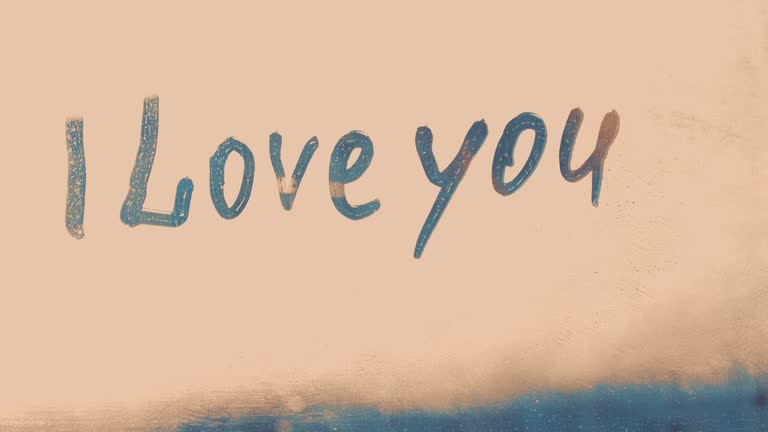 avowal words I love you on foggy glass on blue window