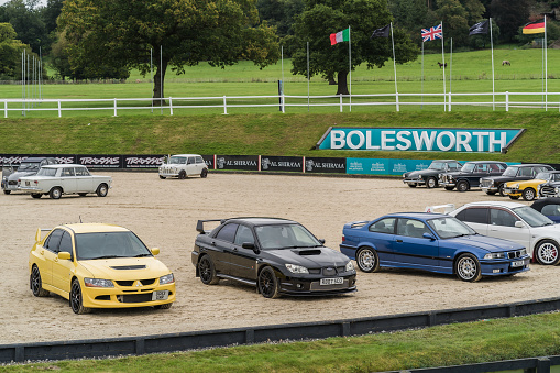 Chester, Cheshire, England, September 30th 2023. Yellow Mitsubishi EVO VIII, black Subaru Impreza RB320 and blue BMW M3 at a classic car display.