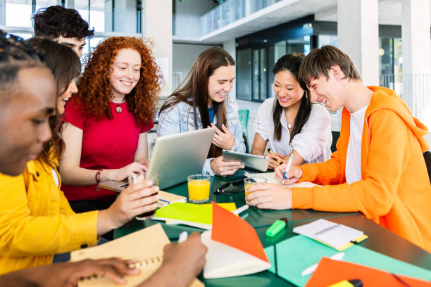 istock Young group of high school students studying together at cafeteria campus table 1813256179