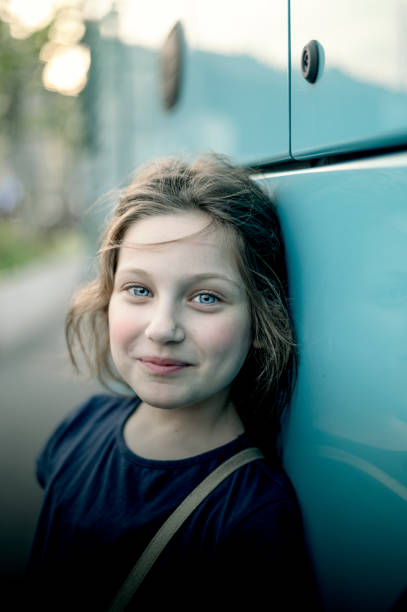 Cute little girl is posing for camera ,she is looking at camera happily