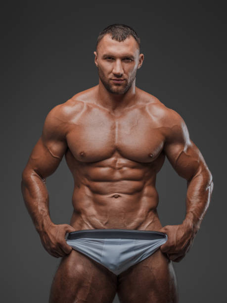 istock Muscular Man in White Briefs on Gray Background 1813256390