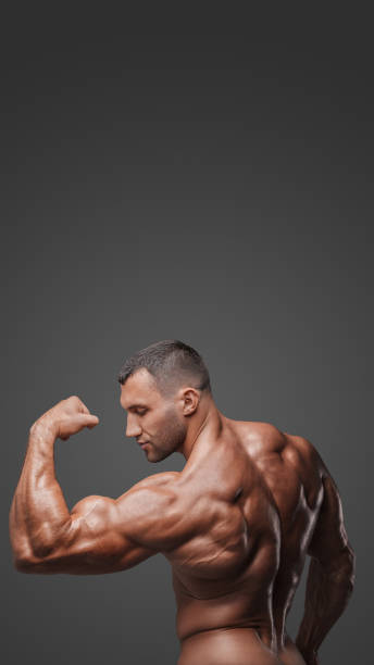 istock Muscular Man with Tense Muscles on Gray Background 1813256913