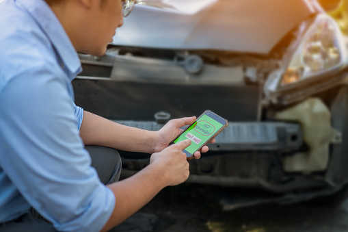 Car insurance agents inspect and evaluate damaged cars after accidents, recording them as evidence for insurance claims.