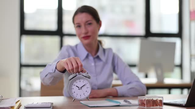 Alarm clock and business woman and work time concept