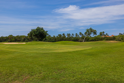 Aruba. Oranjestad. 11.26.2023. Stunning view of golf course with lush green grass against backdrop of clear blue sky on island of Aruba.