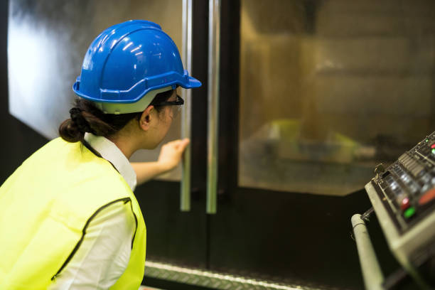 istock Asian inspector with hardhat look at microchip machine in factory 1813264962