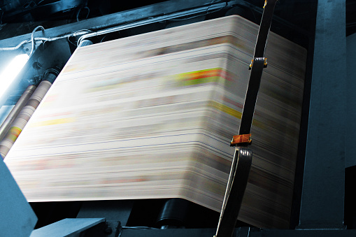 Paper passing through a web offset machine in an italian newspapers printing press