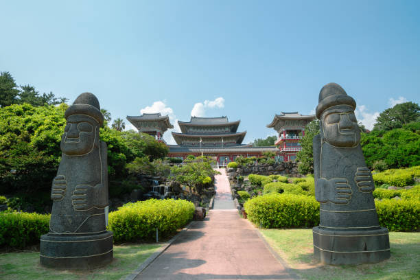 Yakcheonsa Temple and Dol hareubang in Jeju Island, Korea stock photo