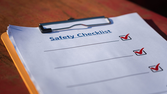 The blank form of safety checklist paper for audit and inspection the machine which is placed at the construction working site. Industrial safety working object. Close-up and selective focus.