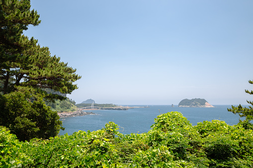 View of Seogwipo port Saeyeongyo Bridge and Munseom Island in Jeju Island, Korea