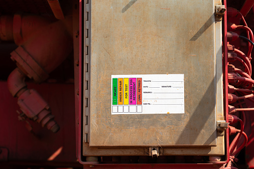 The safety lockout-tagout label using to isolate and verify status of the electric equipment during repair. Industrial safety and equipment symbol.