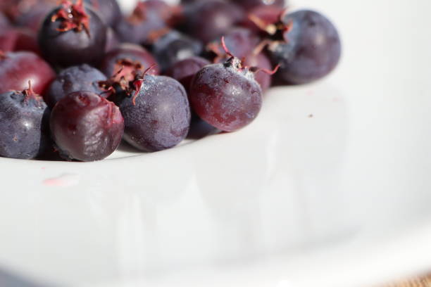 istock Ripe berries lying on a white plate 1813297474
