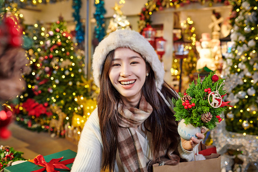 One asia young women shopping christmas present at christmas market.