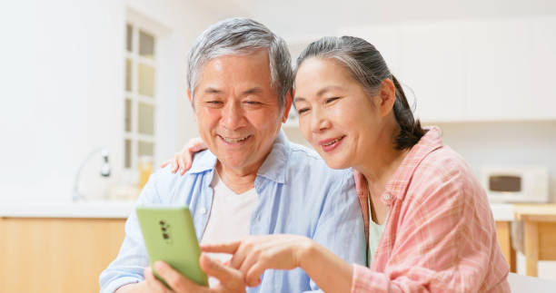 istock old couple look phone 1813307481
