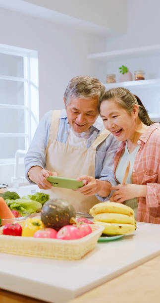 istock Asian elderly couple in kitchen 1813315153