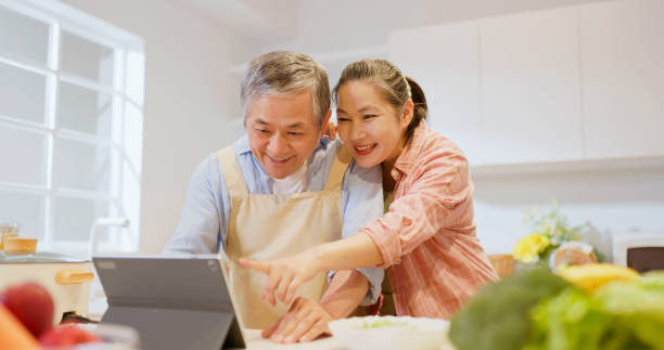 Asian elderly couple in kitchen