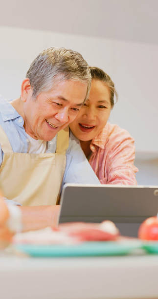 istock Asian elderly couple in kitchen 1813315729