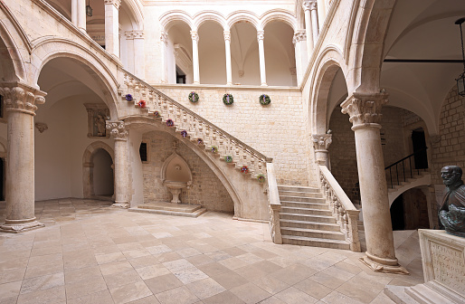 Dubrovnik, Croatia - Aug 22, 2020: Atrium and staircase inside Rector's Palace in old town of Dubrovnik. The palace was used to serve as the seat of the Rector of the Republic of Ragusa between the 14th century and 1808.
