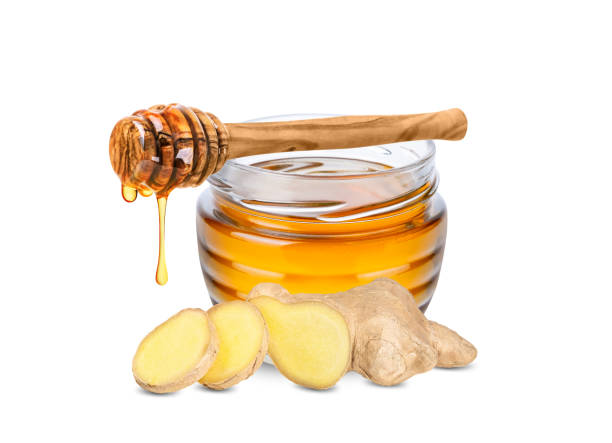 Honey and ginger root isolated on white background.