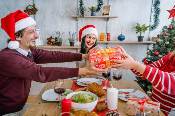istock Friends exchanging gifts on New Year 1813364762