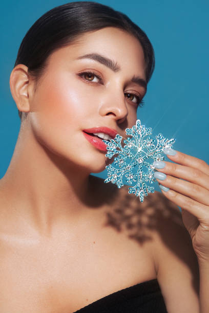 istock Beautiful young woman with glowing snowflake 1813368988