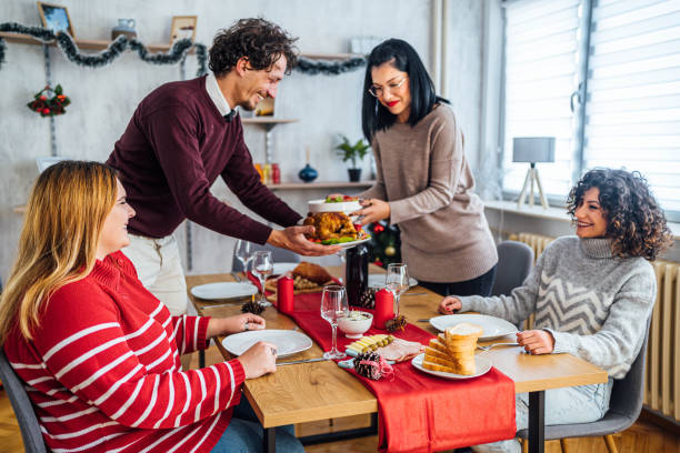istock Friends setting up the table for Christmas lunch 1813370556