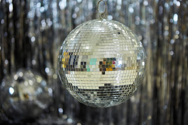 istock A large mirror ball on a shiny background. Reflective surface to create a lighting effect. 1813373263
