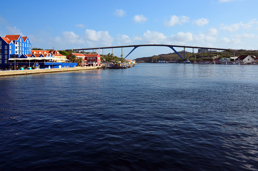 Willemstad, Curaçao, Kingdom of the Netherlands: Queen Juliana Bridge across St. Anna Bay - rigid frame bridge with inclined legs linking Punda to Otrobanda - at 56.4m tall it is the highest bridge in the Caribbean, allowing the passage of most vessels. Buildings in Otrobanda on the left.