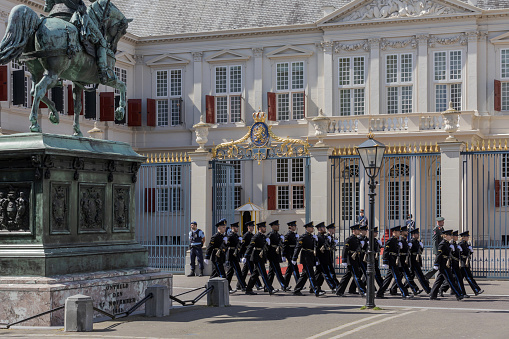 The Hague, The Netherlands - May 24, 2023; military brass band at a ceremony in front of Noordeinde Palace on Wednesday mornings when new ambassadors visit King Willem-Alexander and offer him their letter of credence. The audience includes a ceremony that can be followed from Noordeinde street. The ambassadors arrive by state coach, escorted by horsemen from the Royal Netherlands Mounted Police.