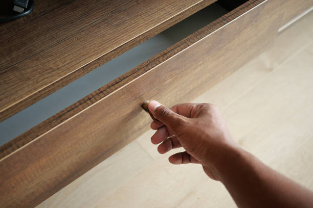 istock man's hand open drawer wooden in cabinet 1813447845
