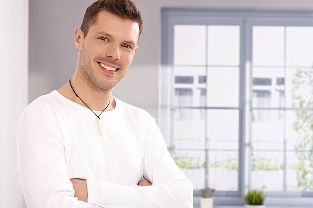 istock Portrait of handsome young man by window 181347782
