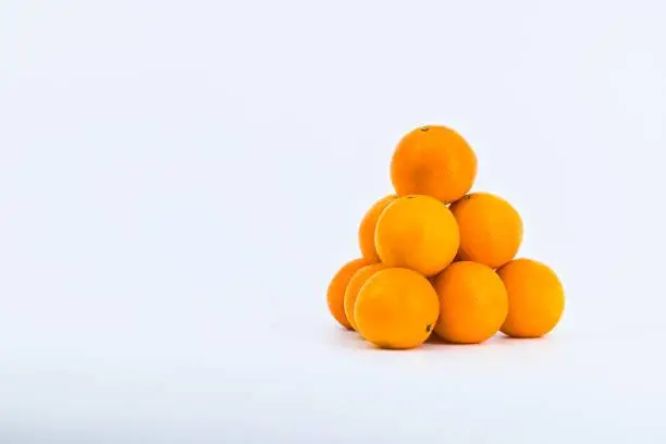 A delightful composition capturing the freshness of mandarins against a clean white backdrop.