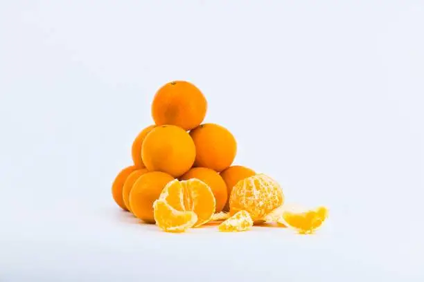 A delightful composition capturing the freshness of mandarins against a clean white backdrop.